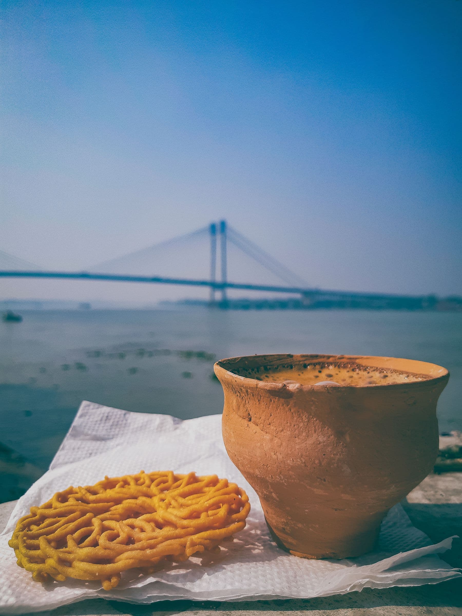 Chai and jalebi by the river